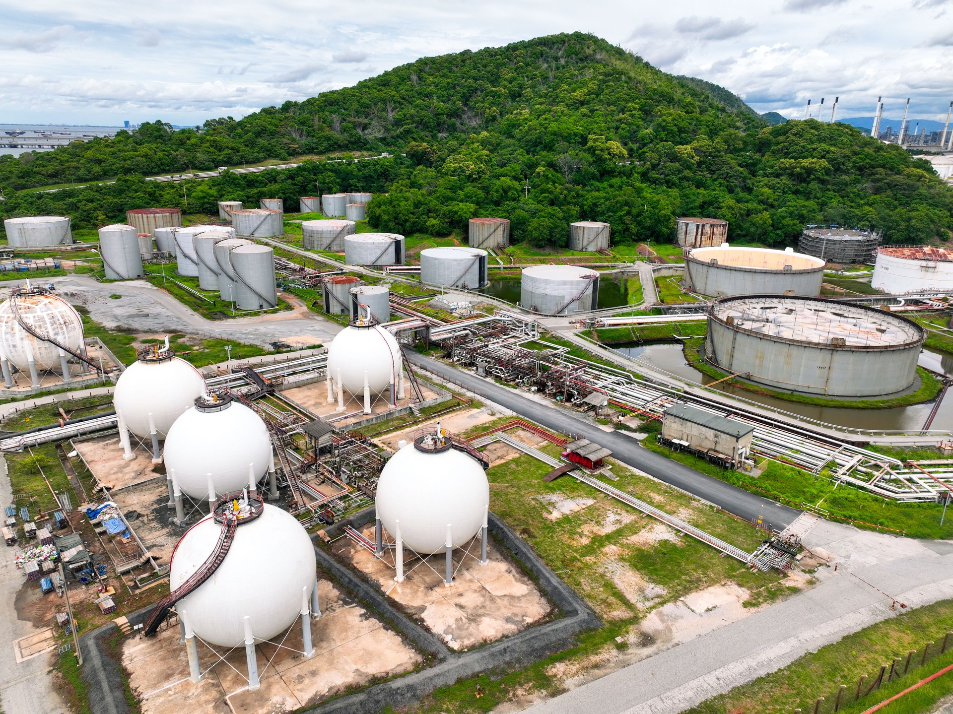 Industrial gas storage tank. LNG or liquefied natural gas storage tank. Gas tank in petroleum refinery. Natural gas storage industry. Energy infrastructure and petroleum reserves in global market.
